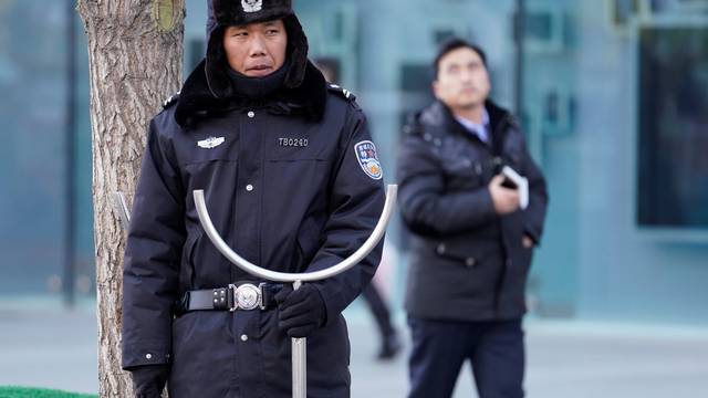 Security personnel stand guard outside the Joy City Mall in the Xidan district after a knife attack, in Beijing