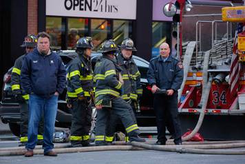 Fire crews stand outside the New York Port Authority Bus Terminal in New York City after reports of an explosion.