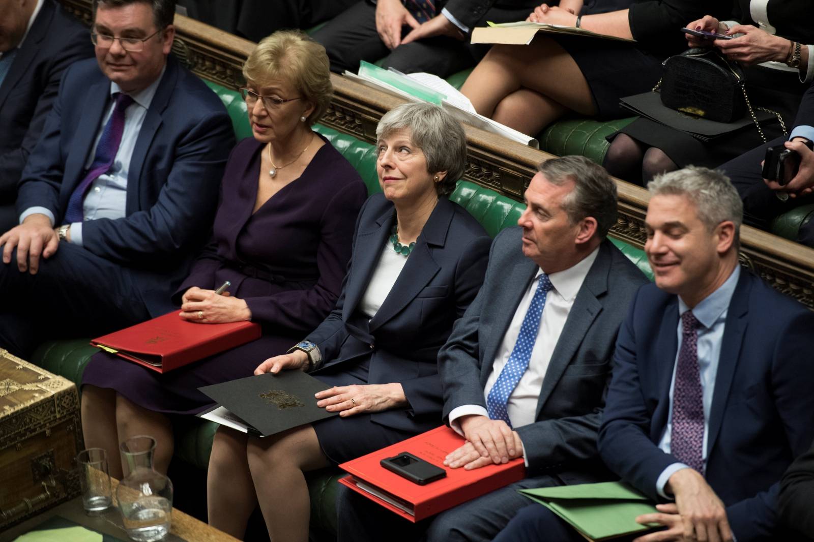 Britain's Prime Minister Theresa May reacts in Parliament following the vote on Brexit in London