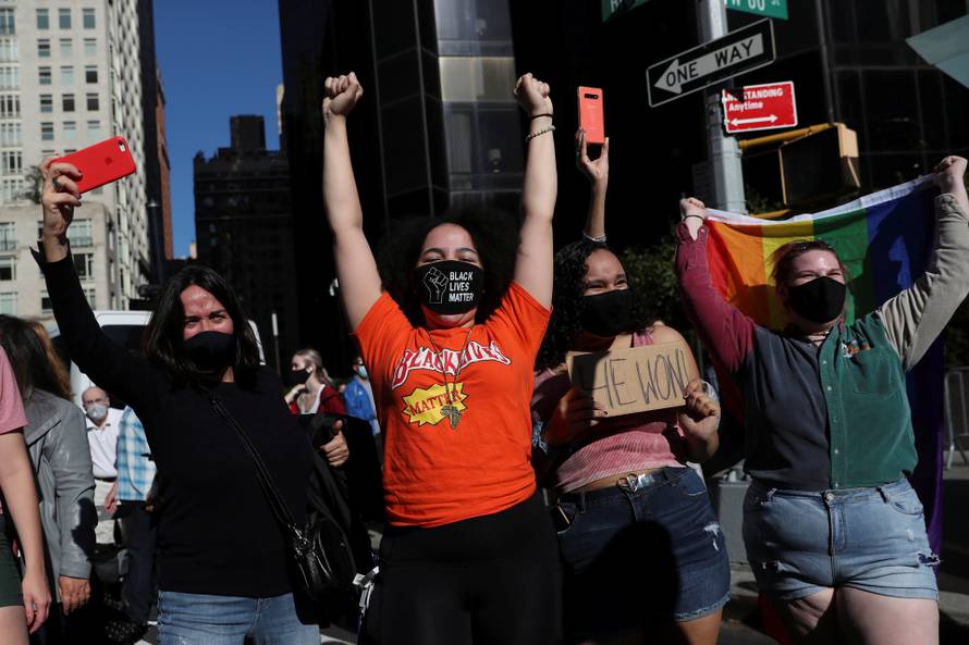 People celebrate media announcing that Democratic U.S. presidential nominee Joe Biden has won the 2020 U.S. presidential election