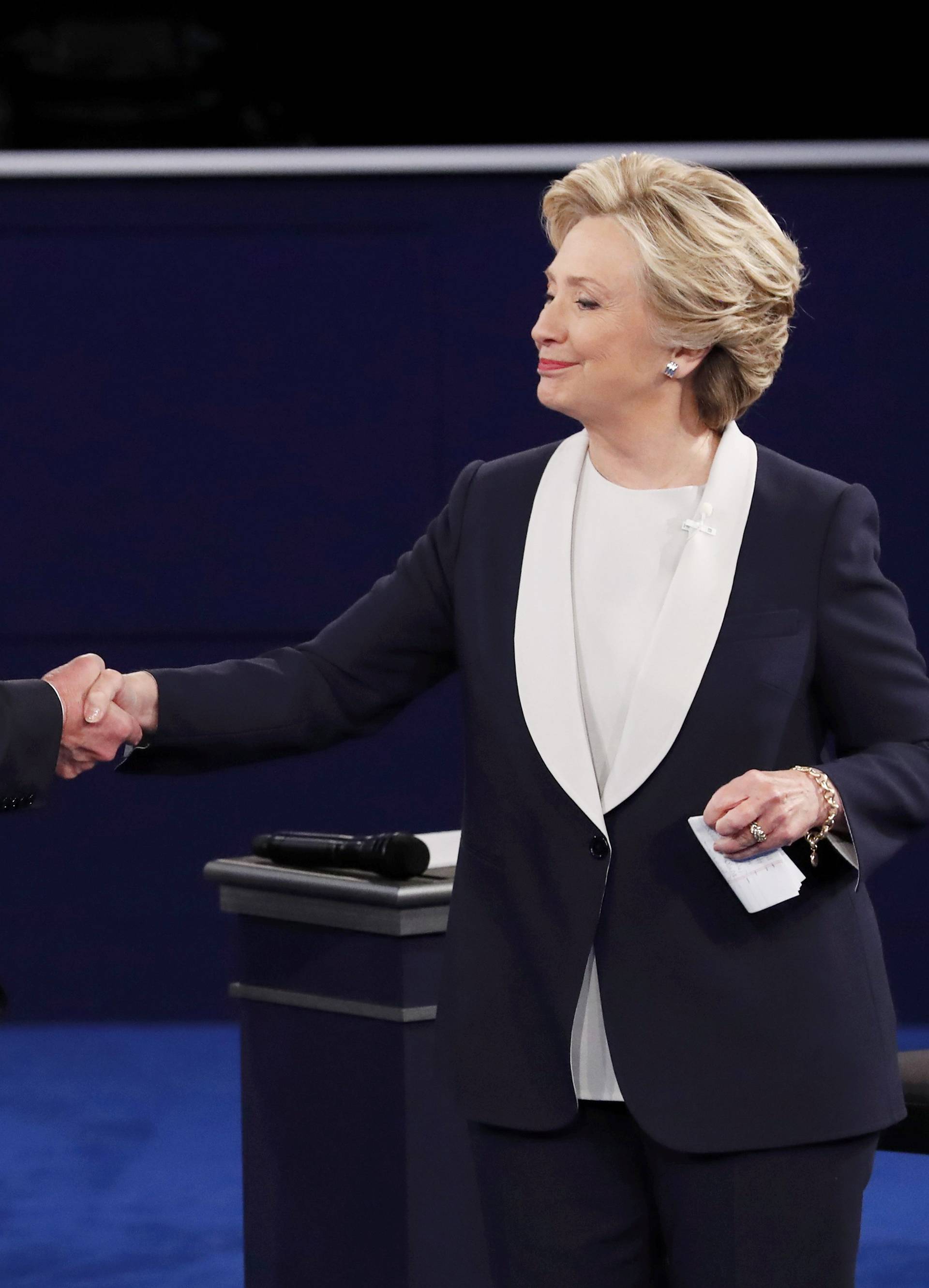 Republican U.S. presidential nominee Donald Trump and Democratic U.S. presidential nominee Hillary Clinton shake hands at the end of their presidential town hall debate at Washington University in St. Louis