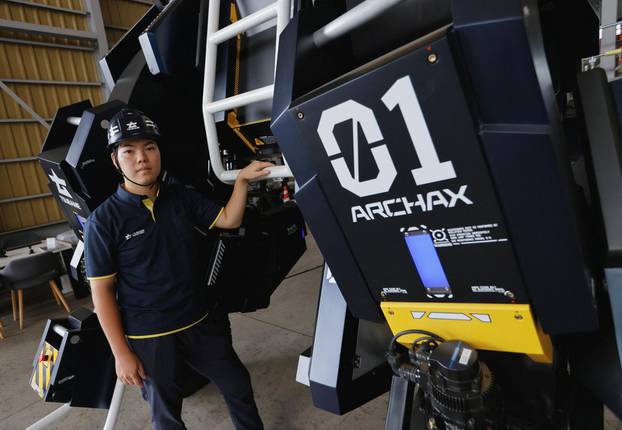 CEO Ryo Yoshida poses for a photograph with ARCHAX, a giant human-piloted robot, in Yokohama, Japan