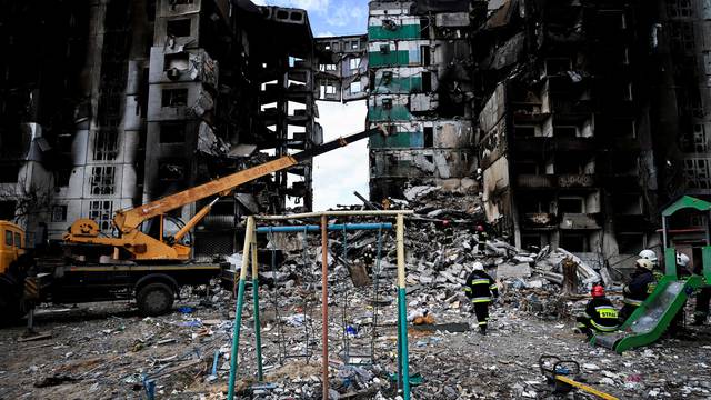 FILE PHOTO: A rescuer walks during a search operation for bodies under the rubble of a building destroyed by Russian shelling, amid Russia's Invasion of Ukraine, in Borodyanka