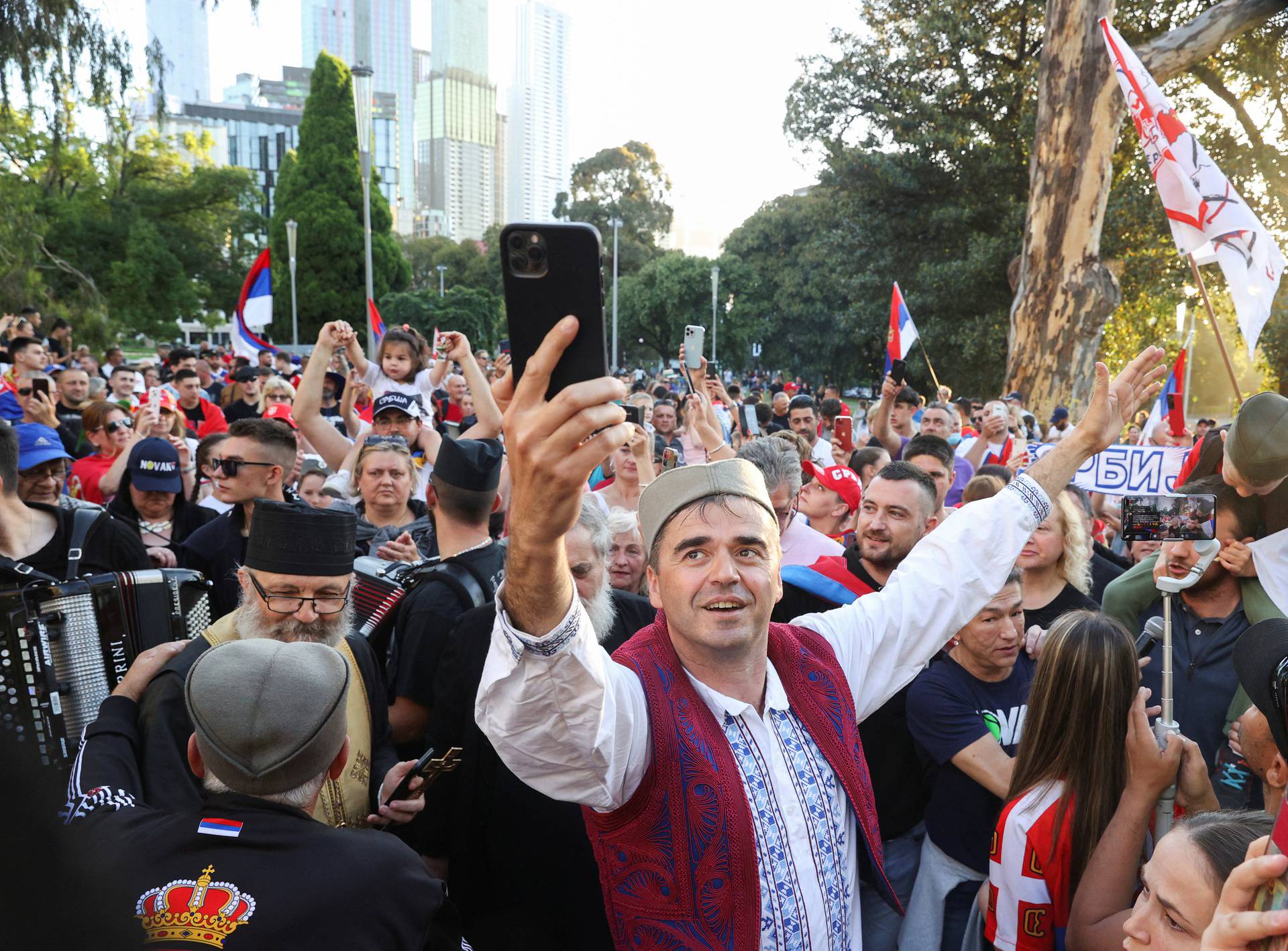 Supporters gather outside the hotel where Novak Djokovic is believed to be held in Melbourne