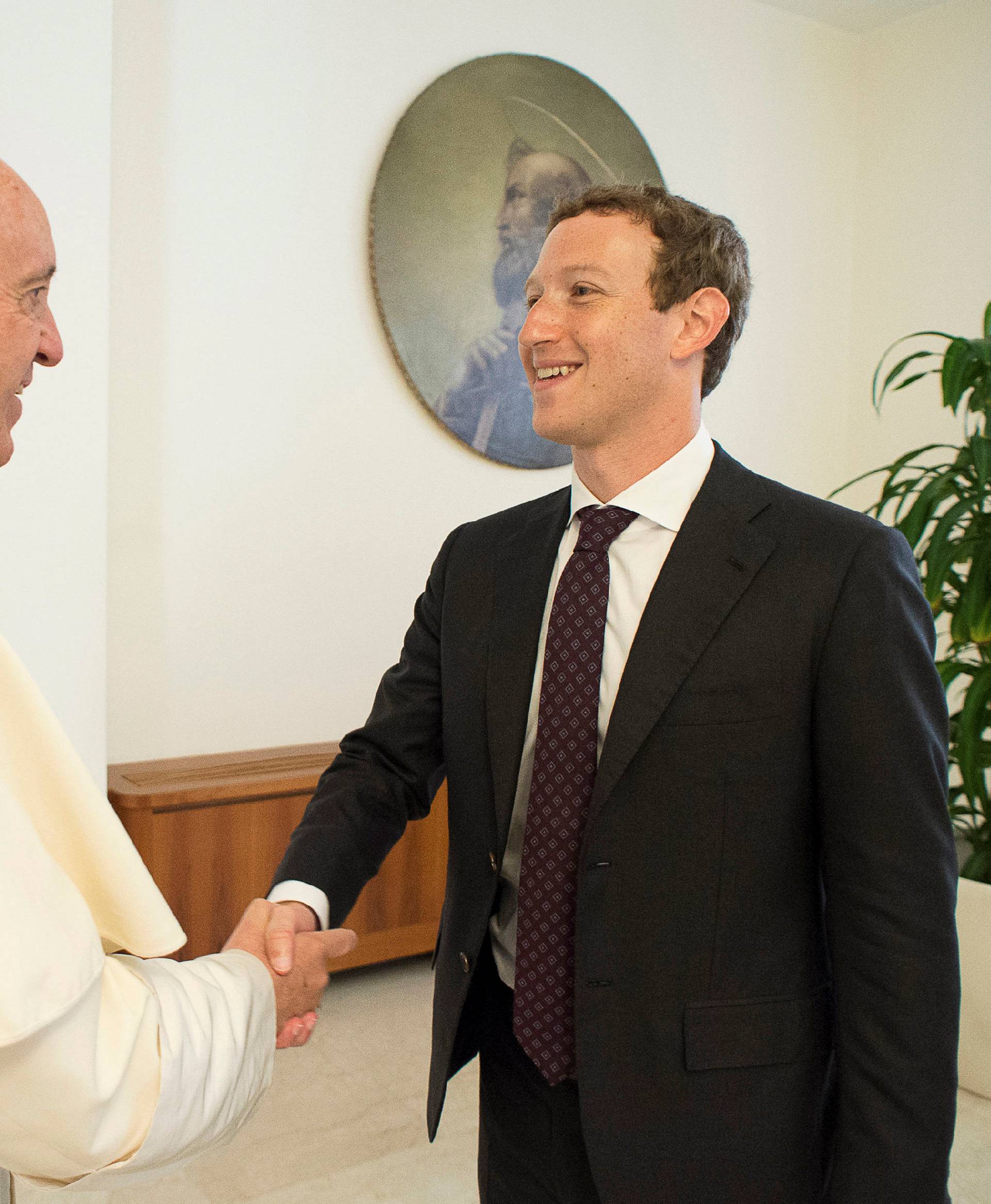 Pope Francis shakes hands with Facebook CEO Zuckerberg during a meeting at the Vatican 