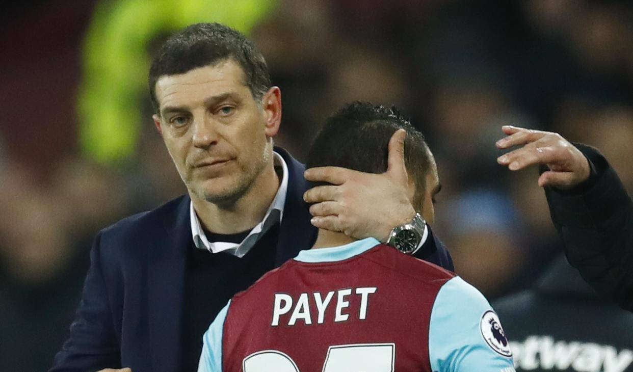 Manchester United manager Jose Mourinho gestures as West Ham United's Dimitri Payet hugs West Ham United manager Slaven Bilic after he is substituted off