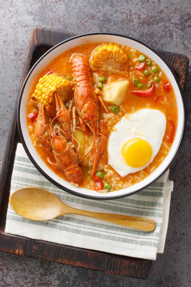 Chupe De Camarones Peruvian Shrimp Chowder close-up on a bowl. V