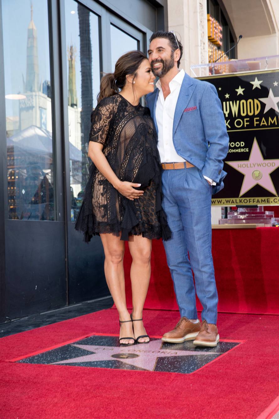 Eva Longoria and her husband Jose 'Pepe' Baston pose on the Hollywood Walk of Fame in Los Angeles
