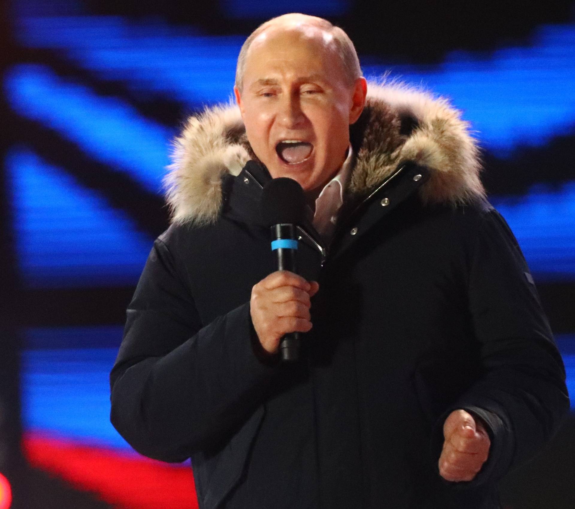 Russian President and Presidential candidate Putin delivers a speech during a rally and concert marking the fourth anniversary of Russia's annexation of the Crimea region, in central Moscow