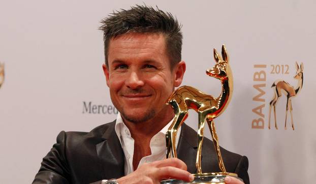 FILE PHOTO: Austrian space jumper Baumgartner poses with his trophy after the 64th Bambi media awards ceremony in Duesseldorf