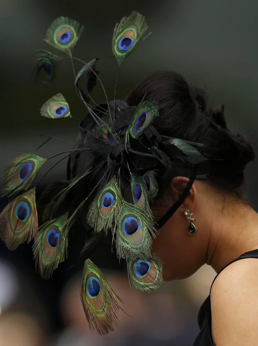 Britain Horse Racing Ladies Day Racegoer wears hat
