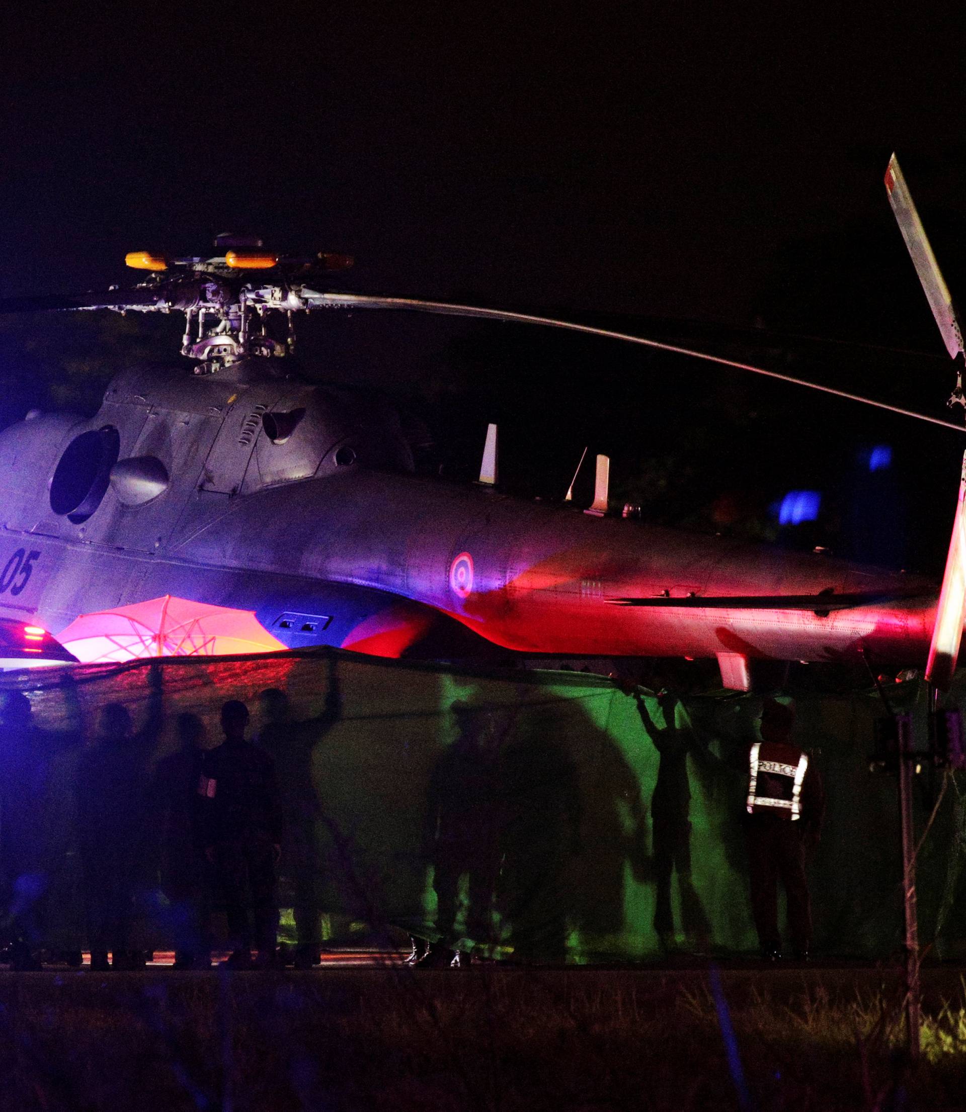 Rescued schoolboys are moved from a military helicopter to an awaiting ambulance at a military airport in Chiang Rai