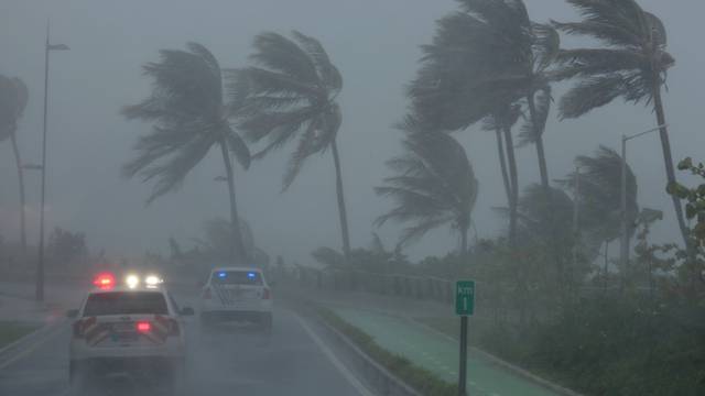 Police patrol the area as Hurricane Irma slams across islands in the northern Caribbean on Wednesday, in San Juan