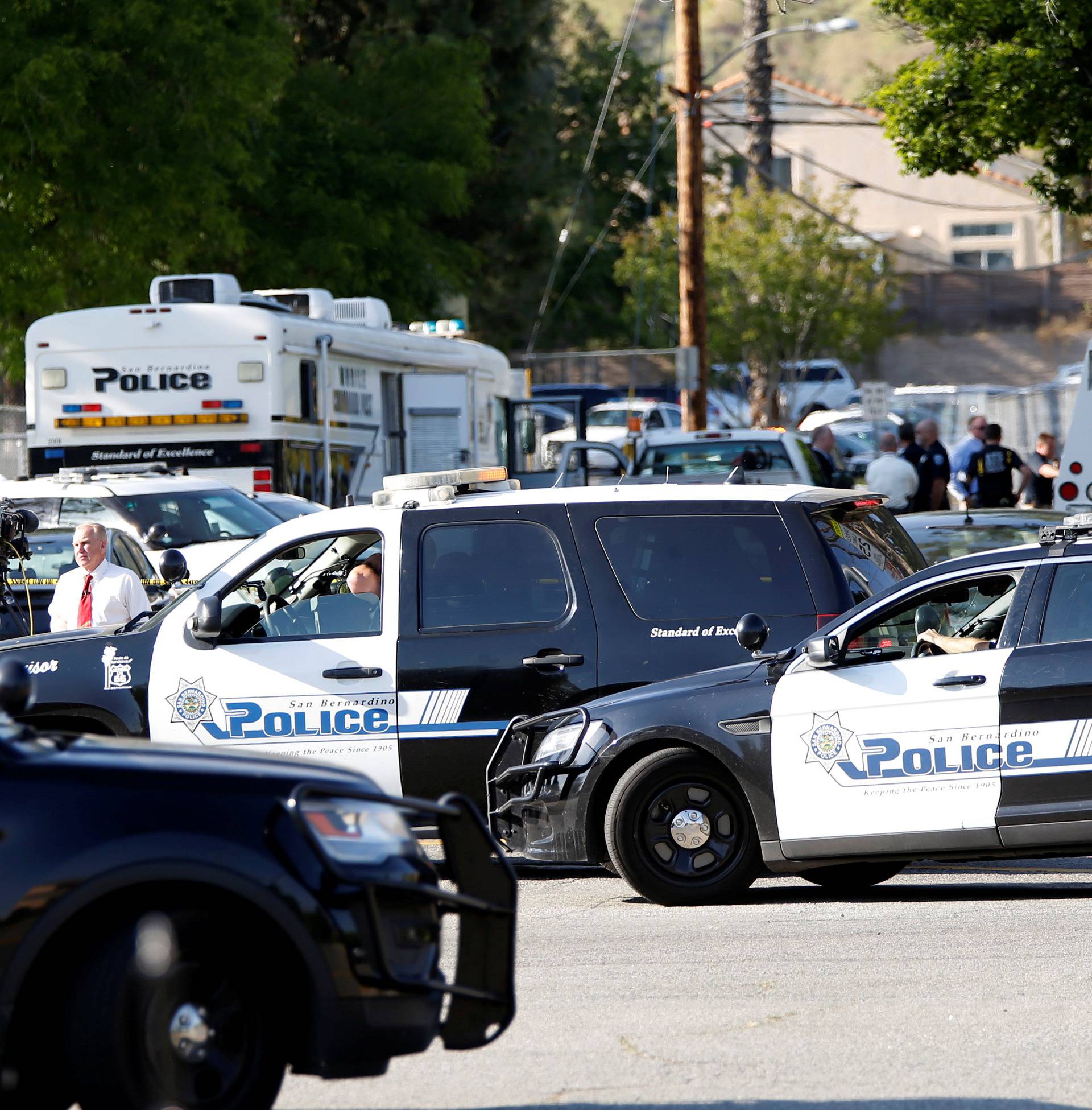 Police vehicles are pictured after a shooting at North Park Elementary School in San Bernardino