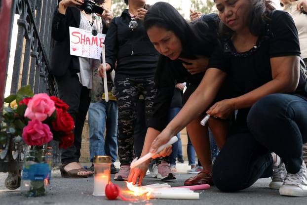 People attend a public gathering in memory of the victims of a suspected serial killer, in Nicosia