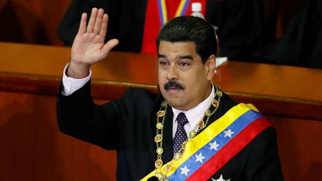 Venezuela's President Maduro waves during his annual report of the state of the nation at the Supreme Court in Caracas
