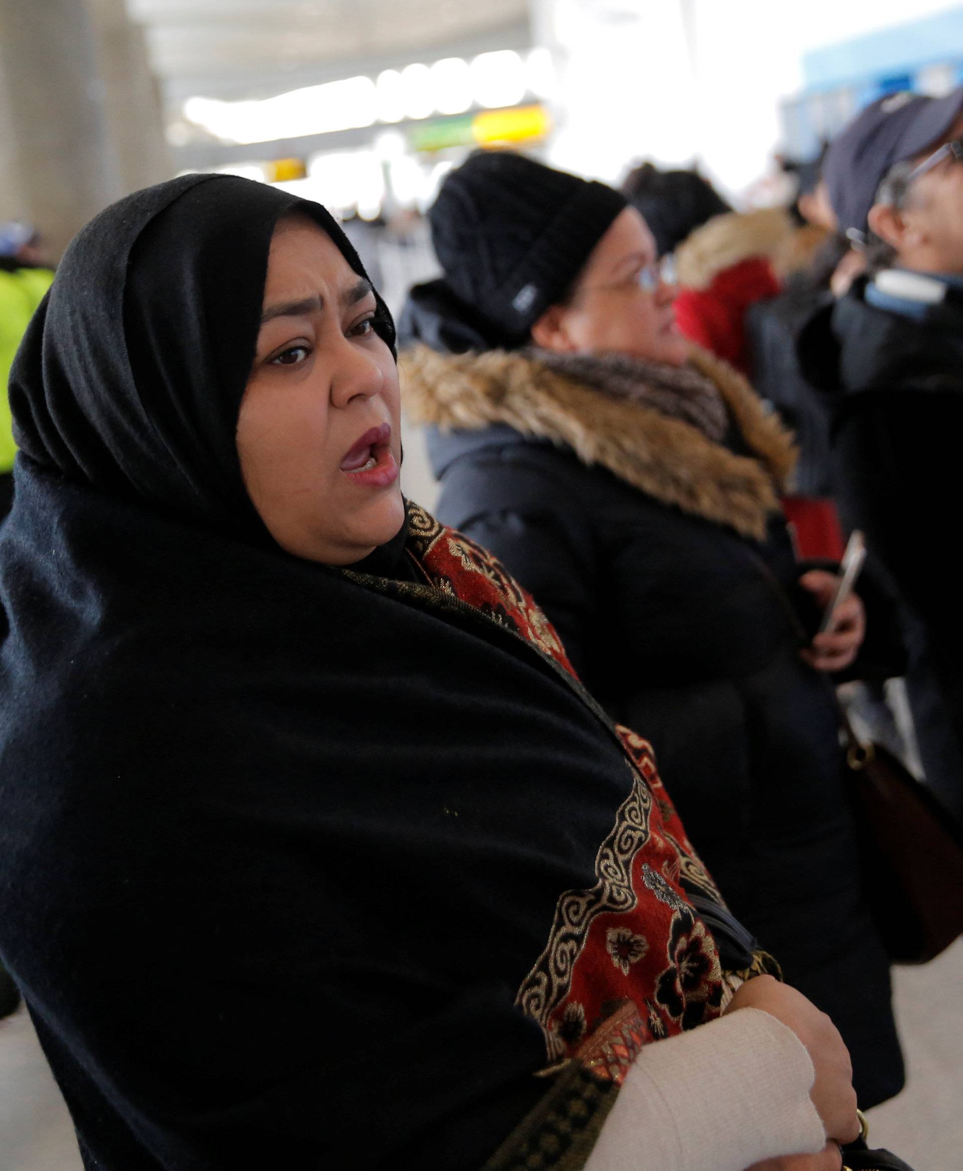 A woman waits for family to arrive at John F. Kennedy International Airport in Queens, New York, U.S.