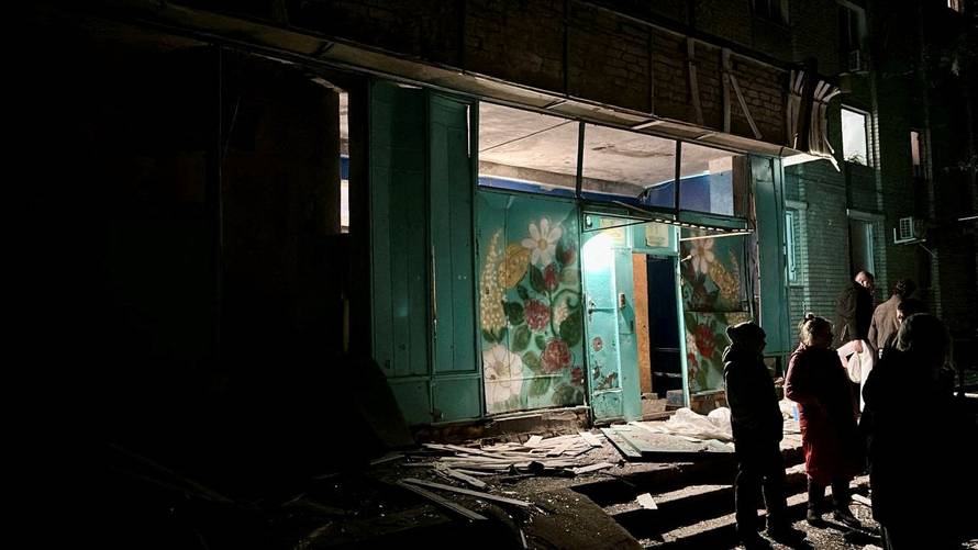 People gather at the site of a Russian mass drone attack at a location given as Dnipro