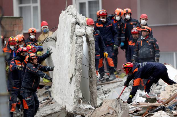 Rescue workers are seen at the site of a collapsed residential building in the Kartal district, Istanbul