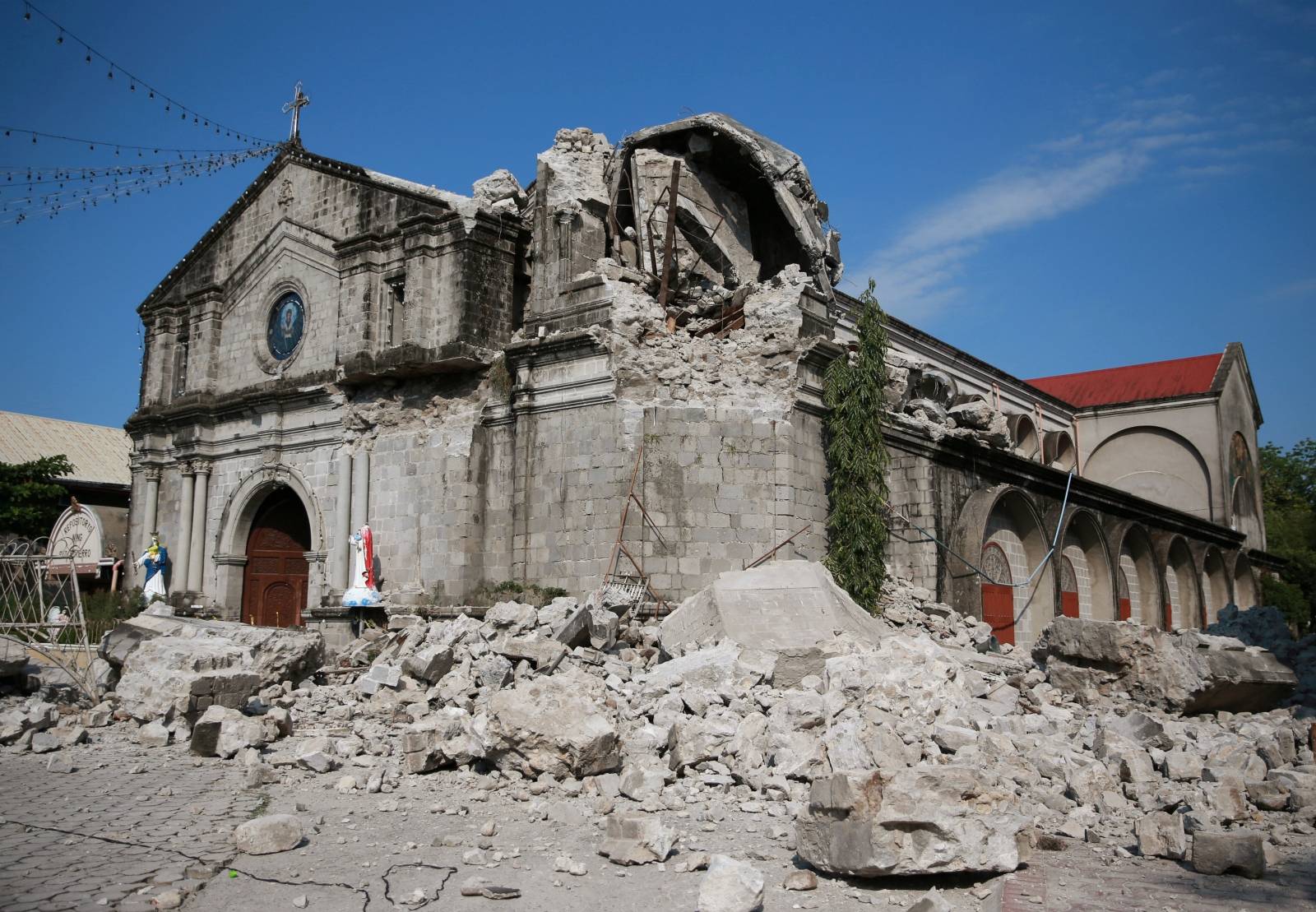 Debris and rubble surround the Santa Catalina de Alejandria Parish after an earthquake the day before in Porac town, Pampanga province