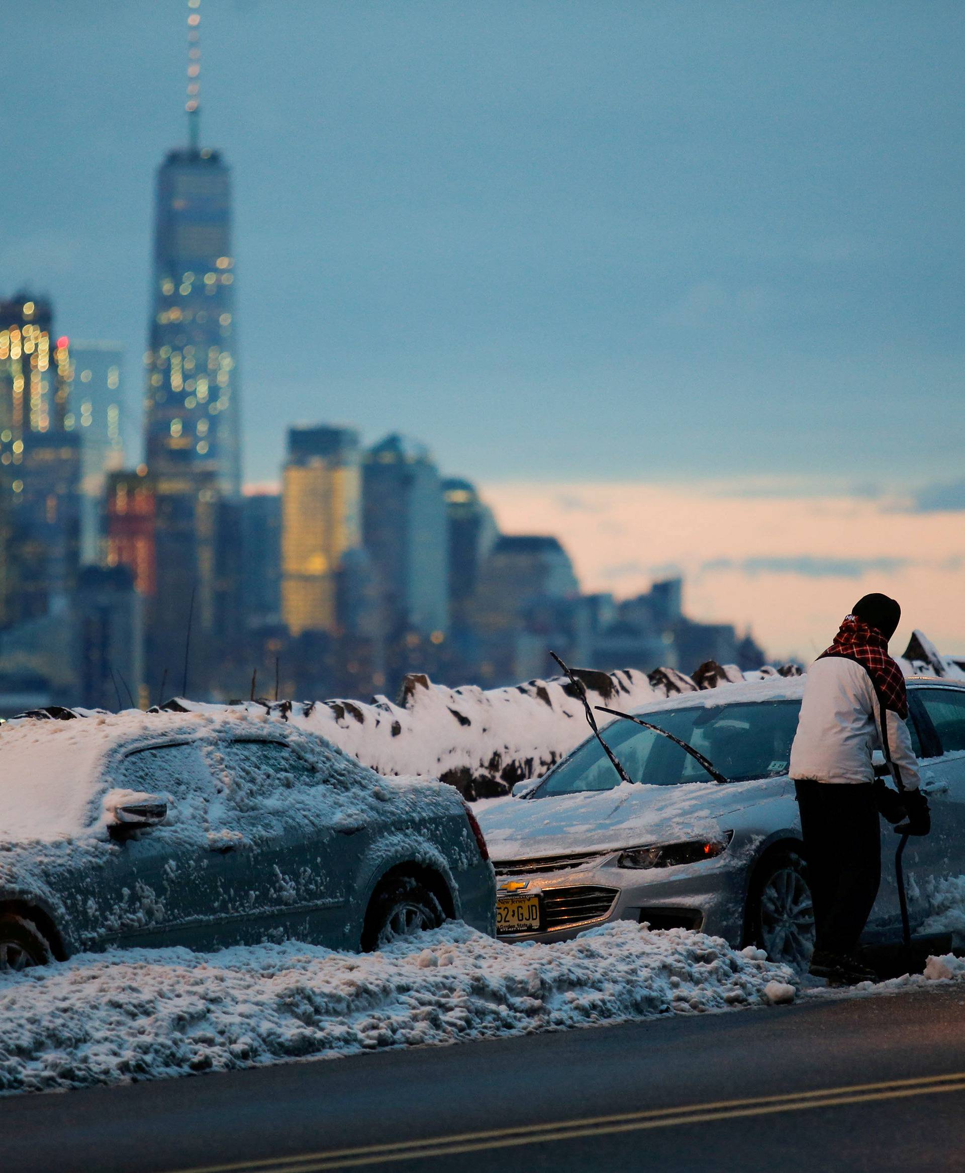 Residents clear their cars and street of snow in Weehawken