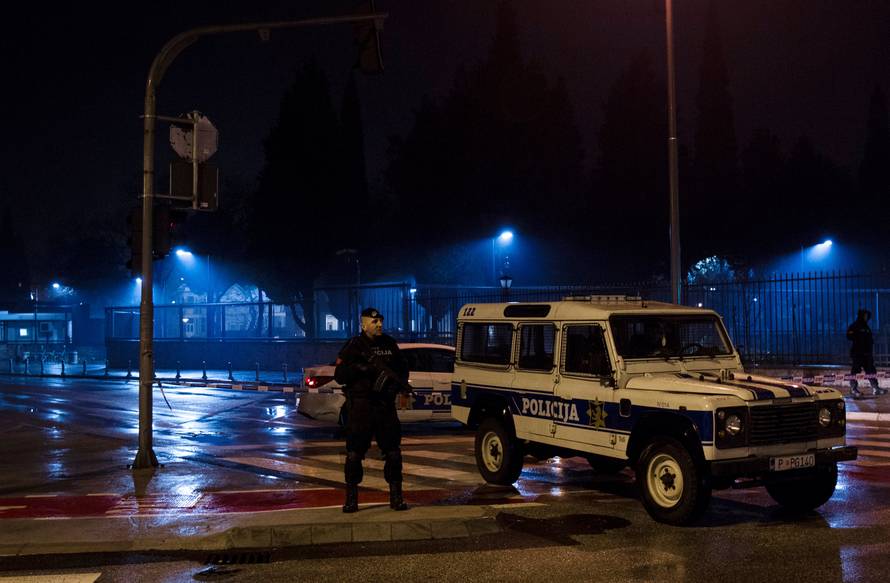 Police guard the entrance to the United States embassy building in Podgorica