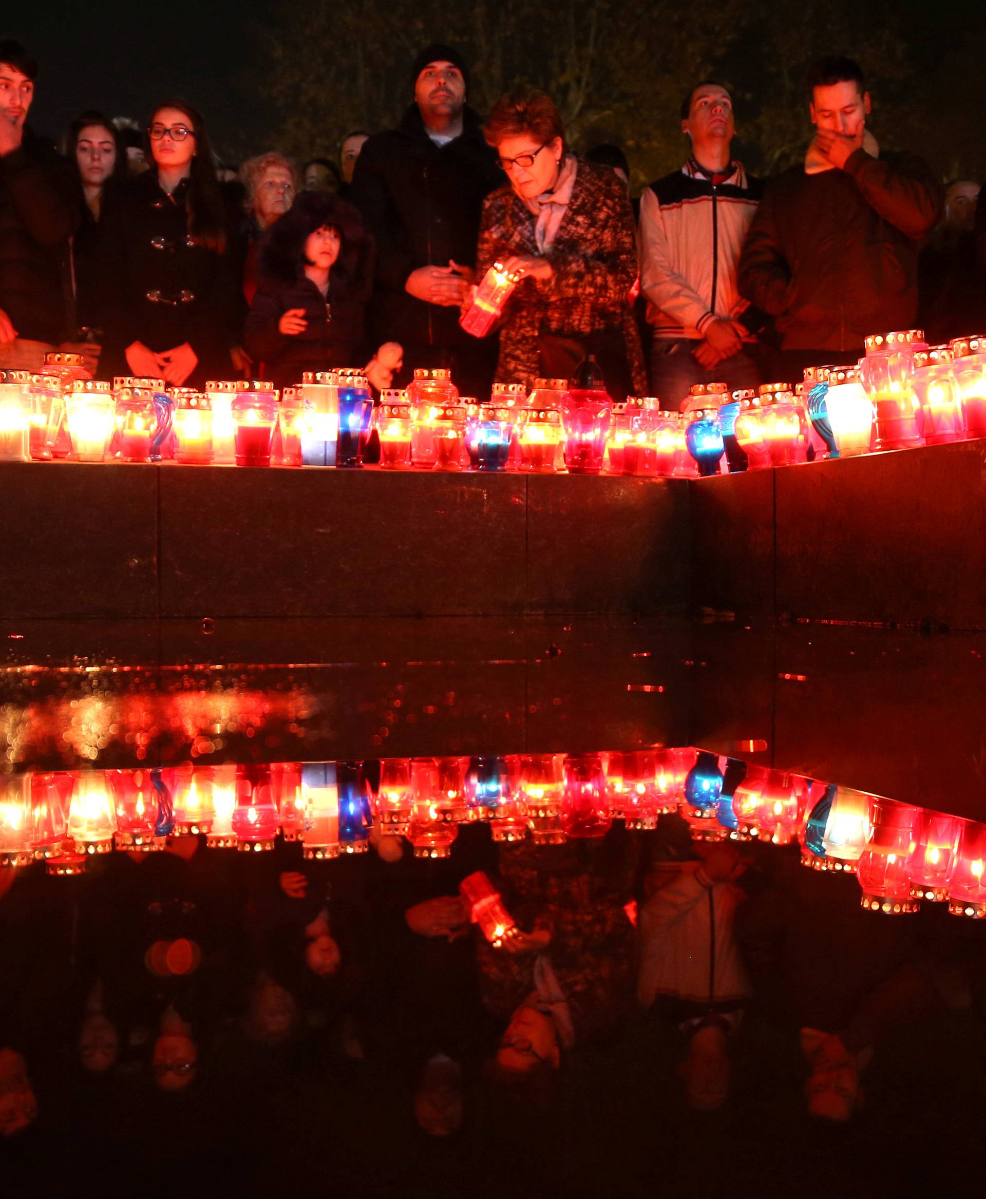 Bosnian Croats pray and light candles for the convicted general Slobodan Praljak who killed himself seconds after the verdict in the U.N. war crimes tribunal in The Hague, in Mostar