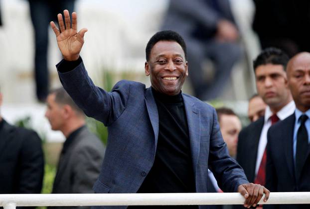 FILE PHOTO: Brazilian soccer legend Pele waves during the international friendly soccer match between Algeria and Slovenia in Algiers