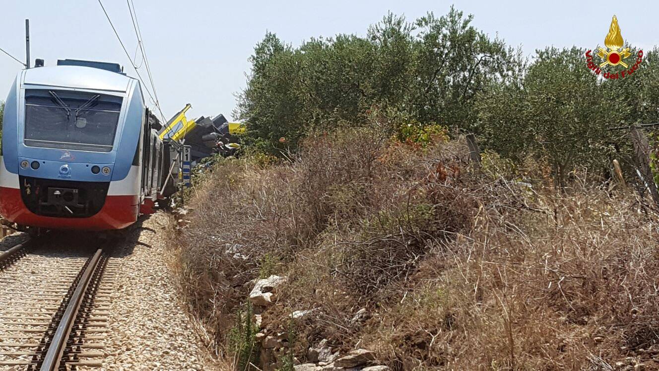 Two passenger trains are seen after a collision in the middle of an olive grove in the southern village of Corato