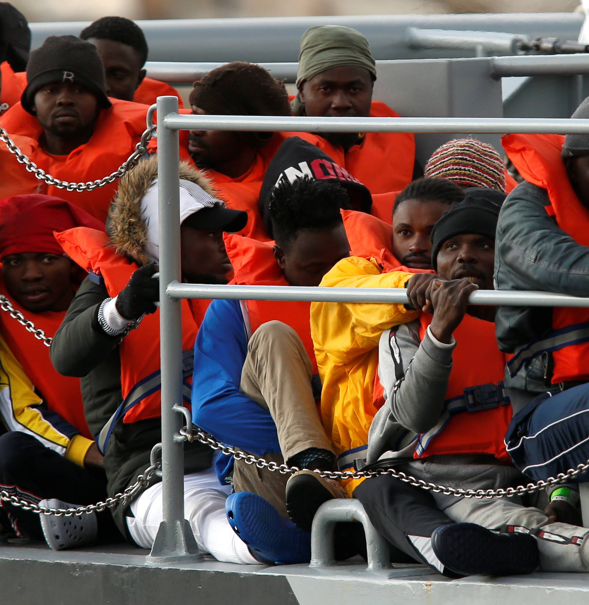 Migrants who were stranded on the German NGO Sea-Eye migrant rescue ship Alan Kurdi are seen before disembarking from an Armed Forces of Malta patrol boat at its base in Marsamxett Harbour, Valletta