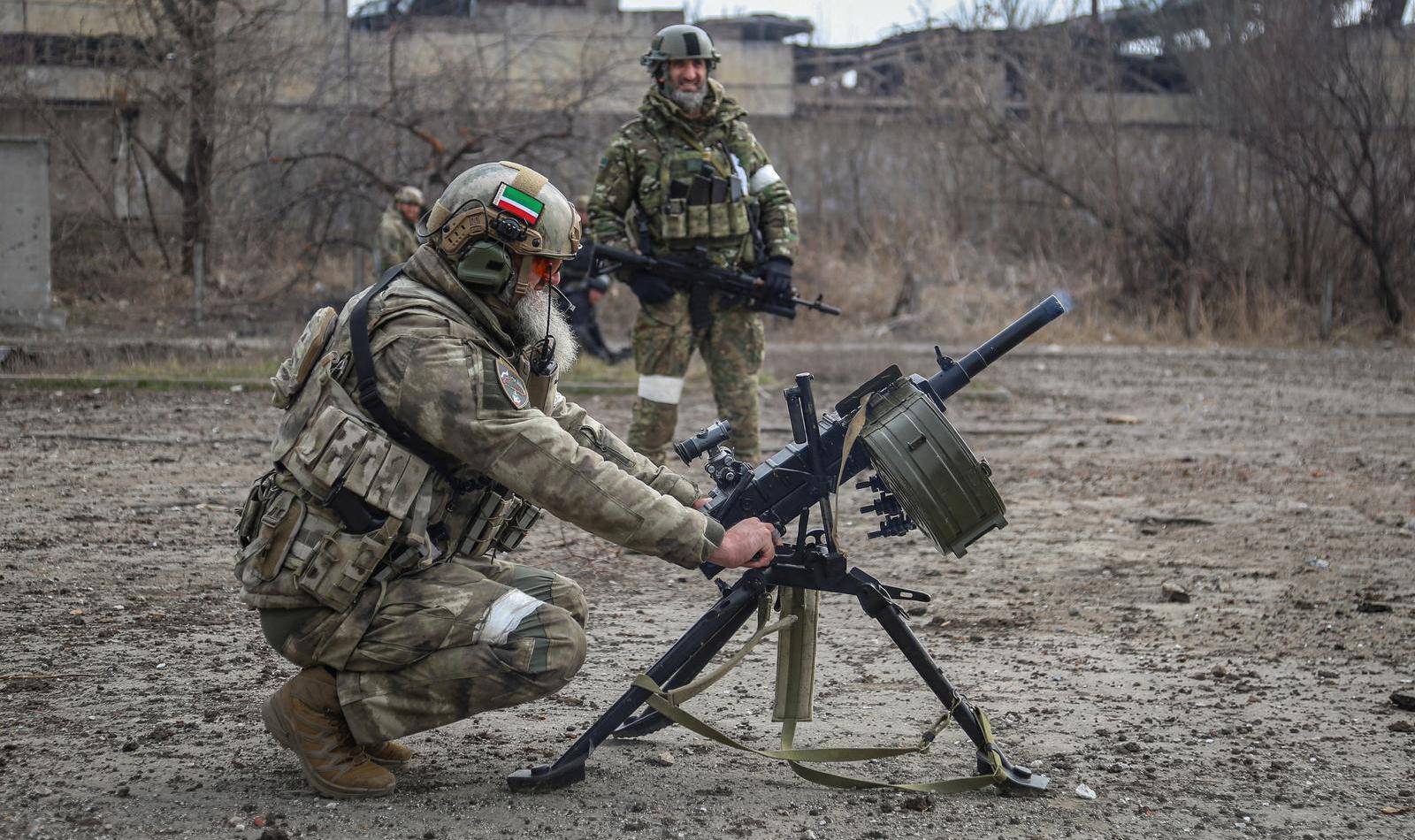 Zamid Chalaev regiment commander from Chechen Republic fires an automatic grenade launcher during fighting in Ukraine-Russia conflict in the city of Mariupol