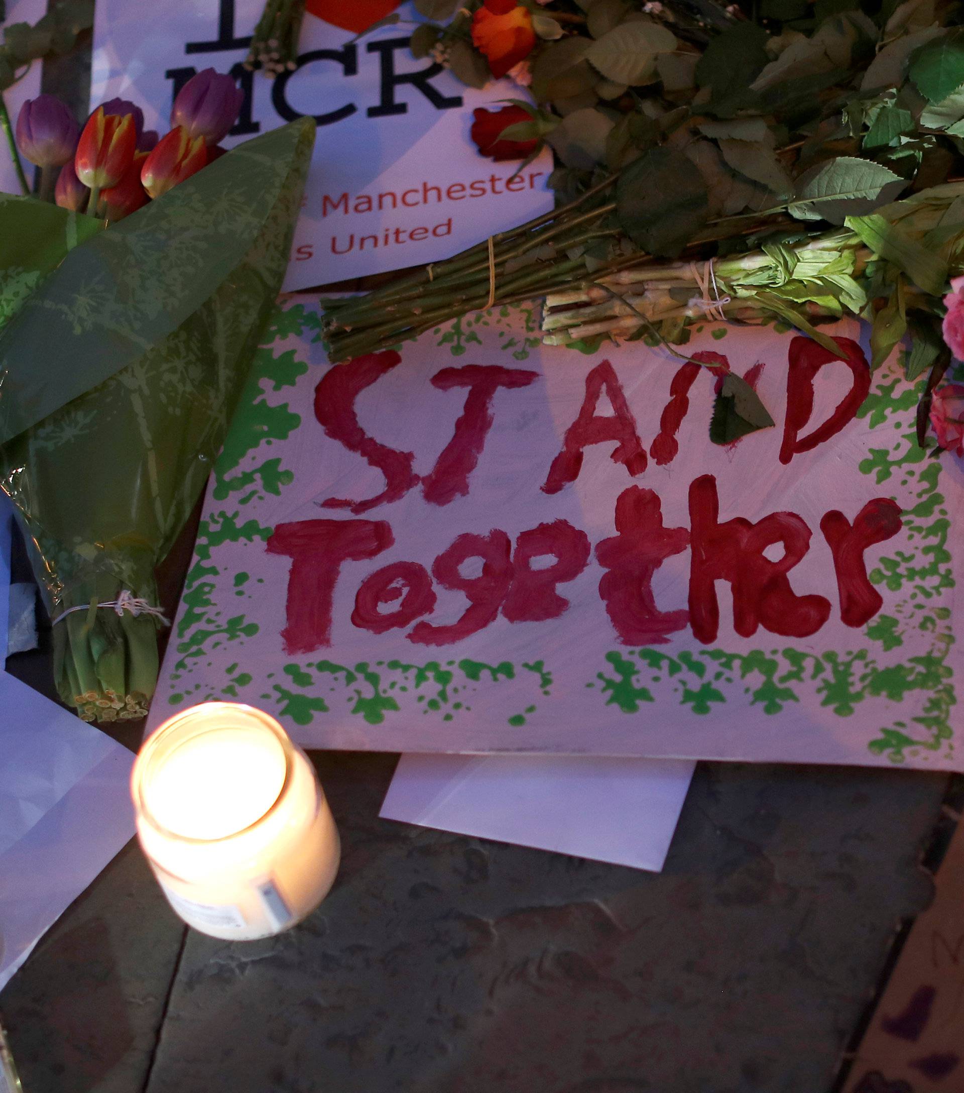 Candles and messages of solidarity are seen following a vigil in central Manchester