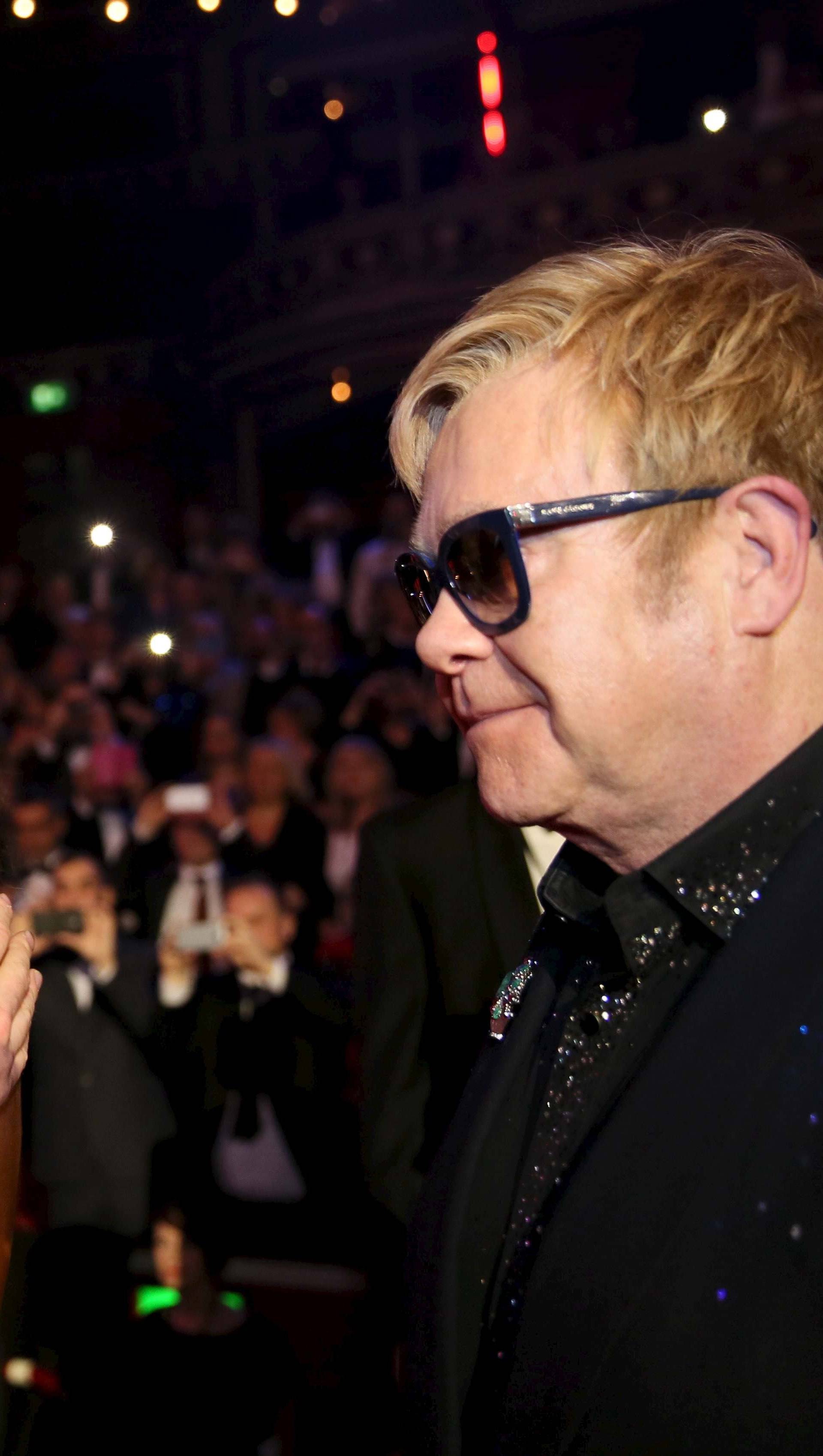 Britain's Prince Harry kisses Beverley Knight as Elton John looks on, after the Royal Variety Performance at the Albert Hall in London