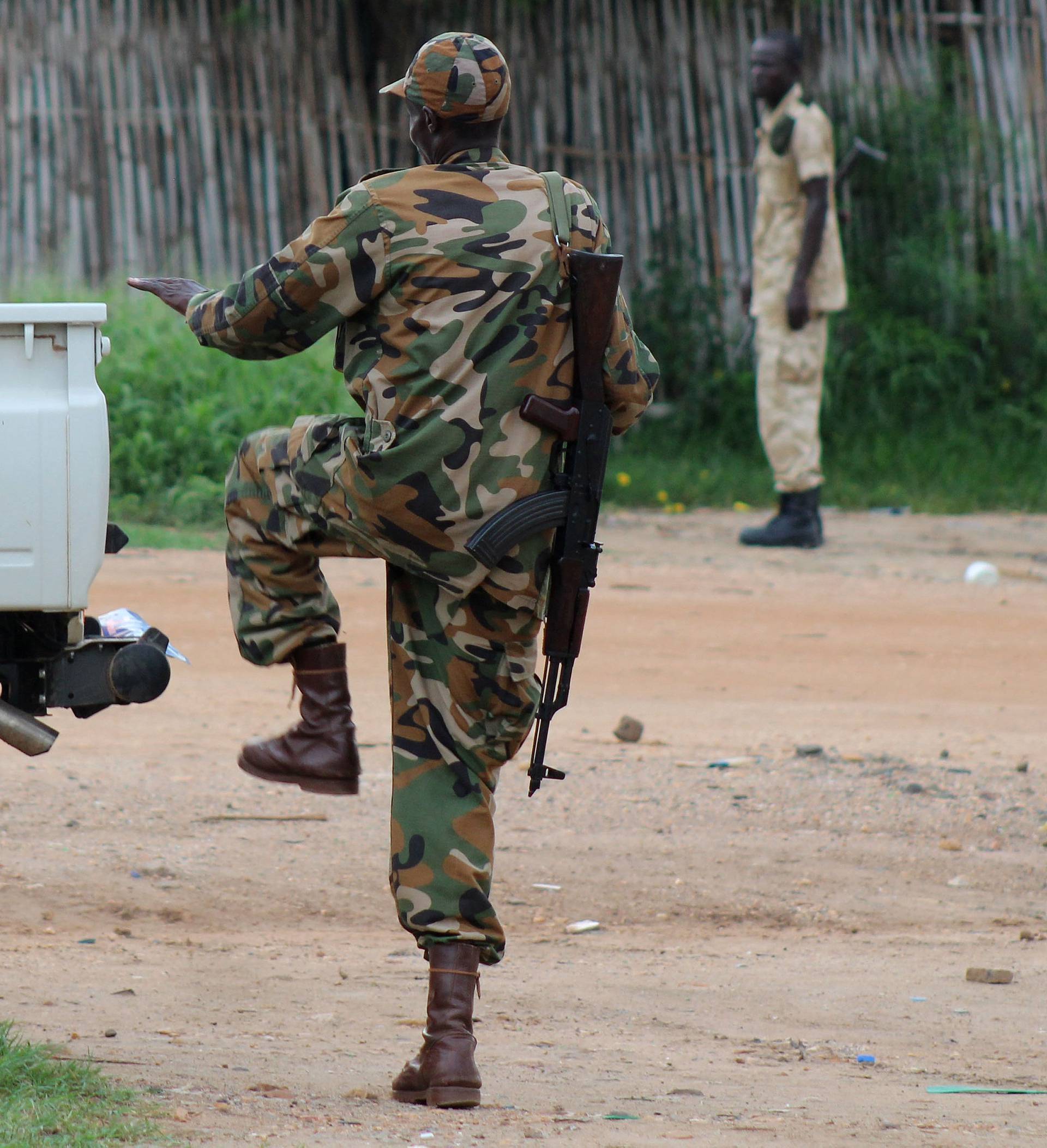 South Sudanese policemen and soldiers stand guard along a street following renewed fighting in South Sudan's capital Juba 