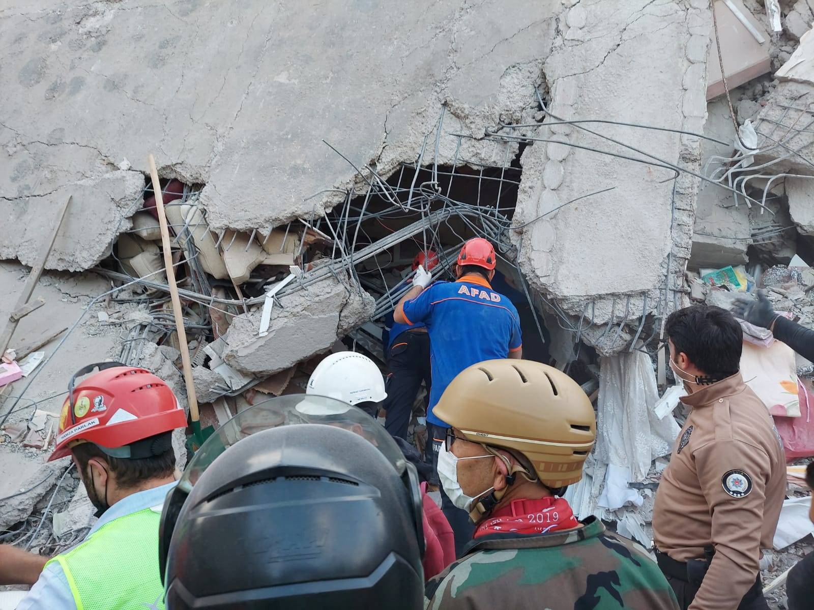 People search for survivors at a collapsed building after a strong earthquake struck the Aegean Sea where some buildings collapsed in the coastal province of Izmir