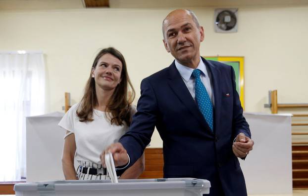 SDS leader Jansa and his wife cast their votes at a polling station during the general election in Velenje