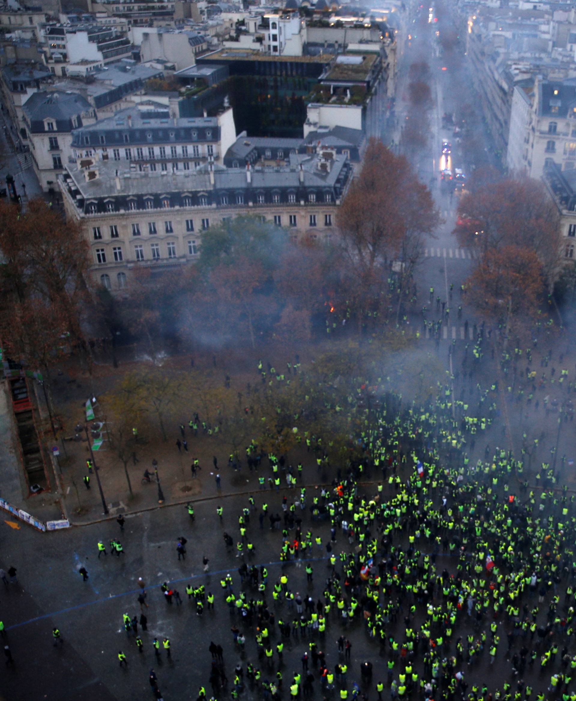 A view shows police forces and protesters wearing yellow vests, a symbol of a French drivers' protest against higher diesel taxes, during clashes as part of a demonstration near the Place de l'Etoile in Paris