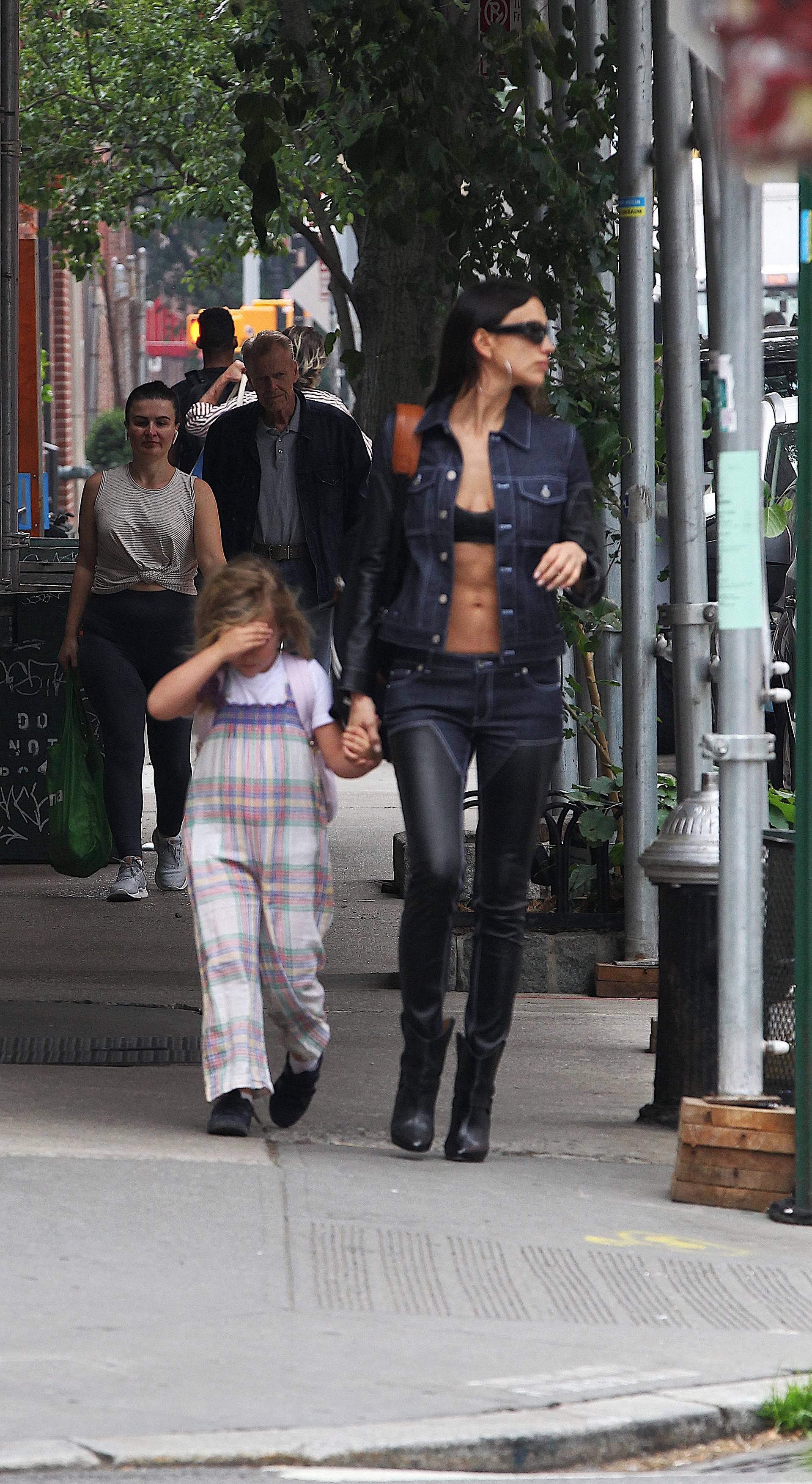Irina Shayk flashes her bra and taut tummy in double-denim outfit to pick up daughter Lea from school in NYC