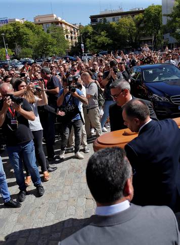 Men carry the coffin containing the body of Spanish footballer Reyes in Seville