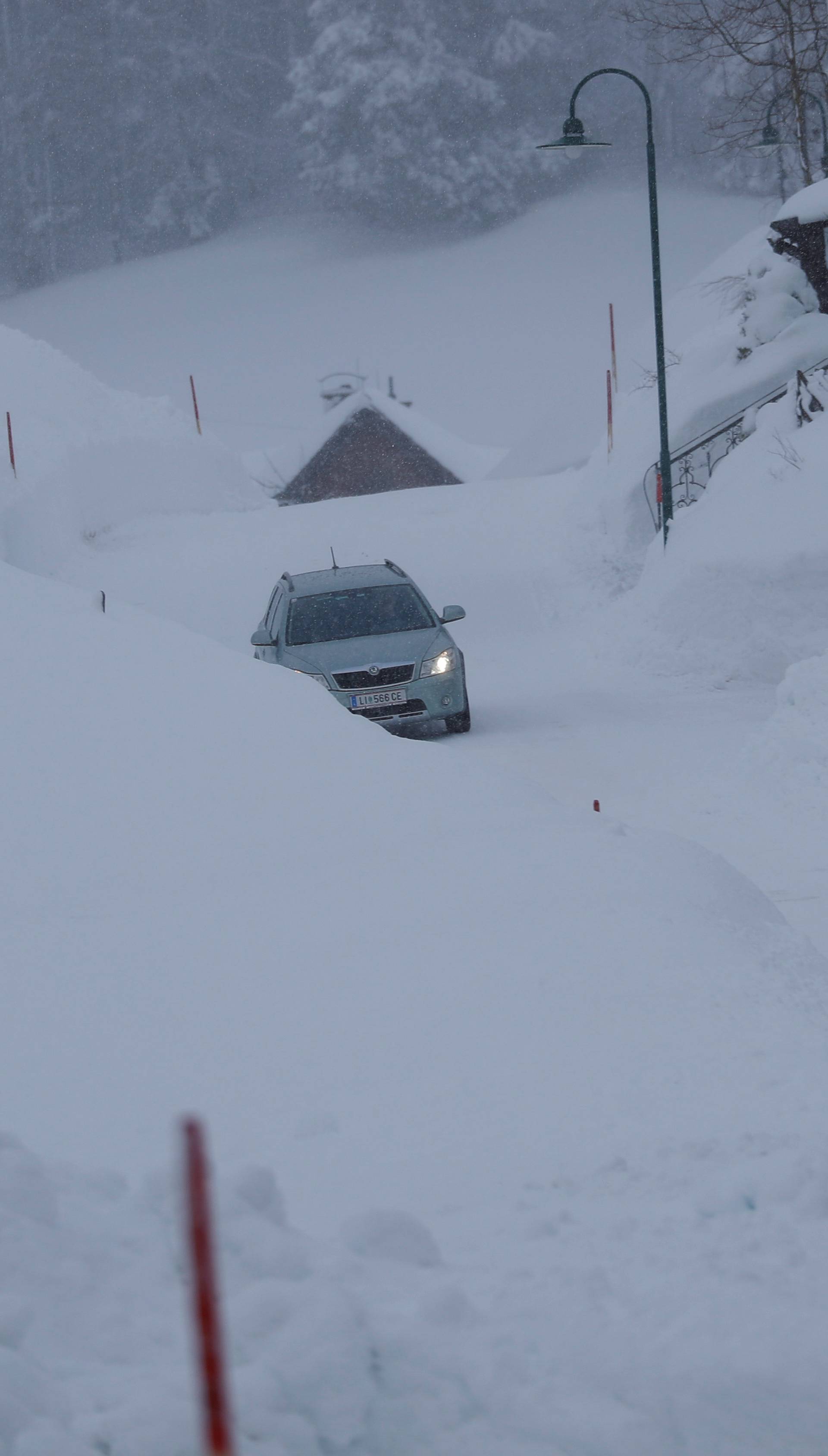 A car drives on an icy road after heavy snowfall in Knoppen