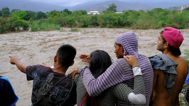 People look towards the Tachira River on the border between Colombia and Venezuela, in Cucuta
