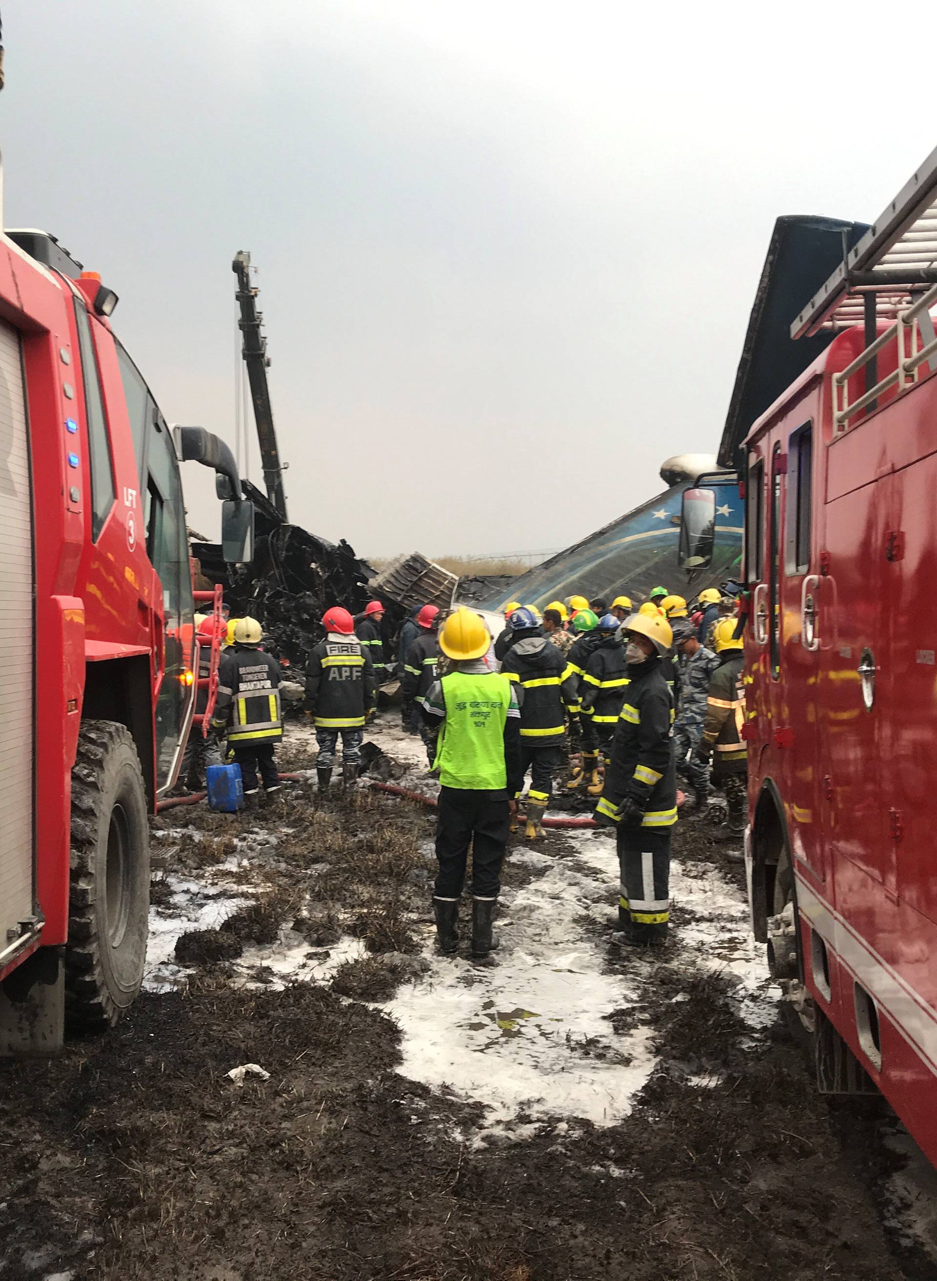 Wreckage of an airplane is pictured as rescue workers operate at Kathmandu airport