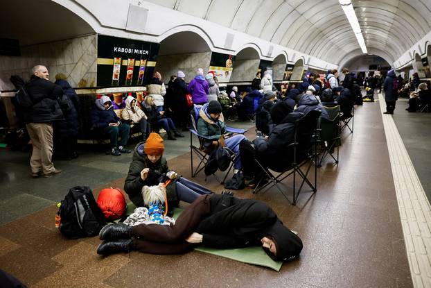 People take shelter at a metro station during an air raid alert, in Kyiv