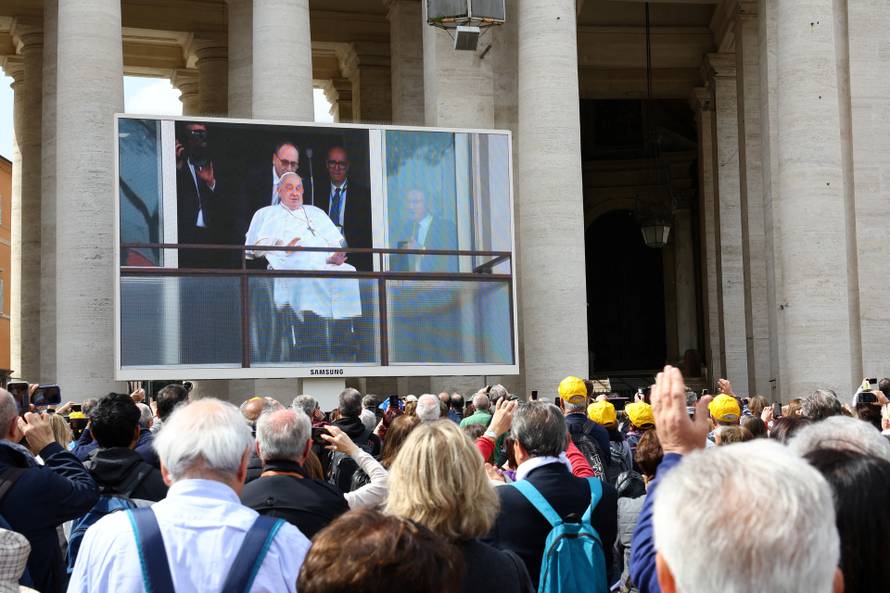 Pope Francis appears from a window of Gemelli Hospital during his first public appearance in five weeks, on a big screen in St. Peter's Square, at the Vatican