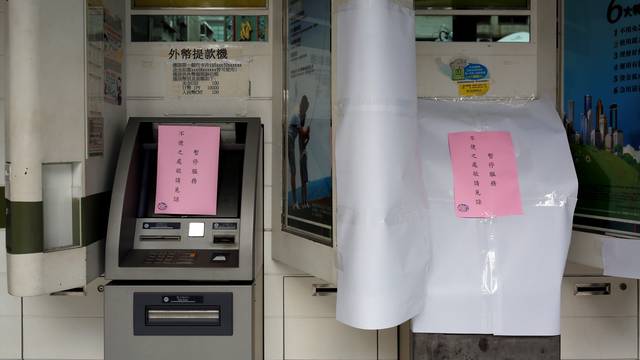 Taiwanese First Bank automated teller machines are seen suspended after T$70 million was reported stolen from its automated teller machines (ATM) in Taipei