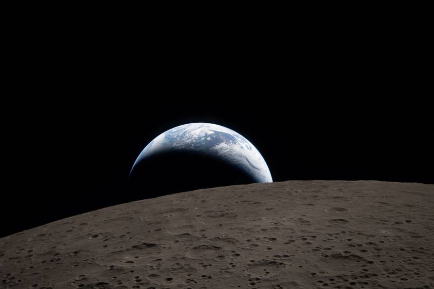 A view of Earth, partially hidden behind the Moon, captured through the Orion spacecraft window