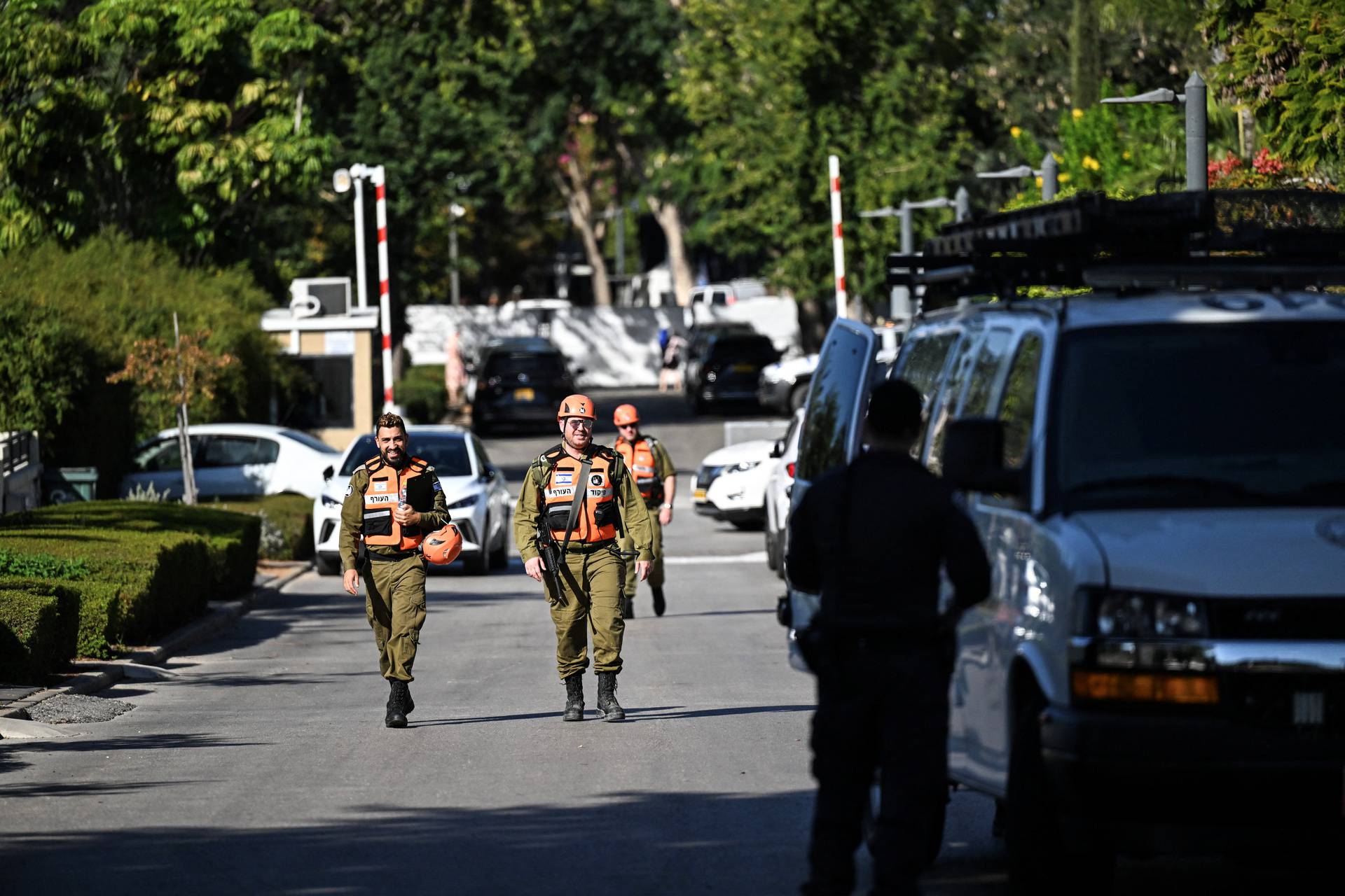 Israeli Home Front Command soldiers walk in Caesarea, following drone attack from Lebanon