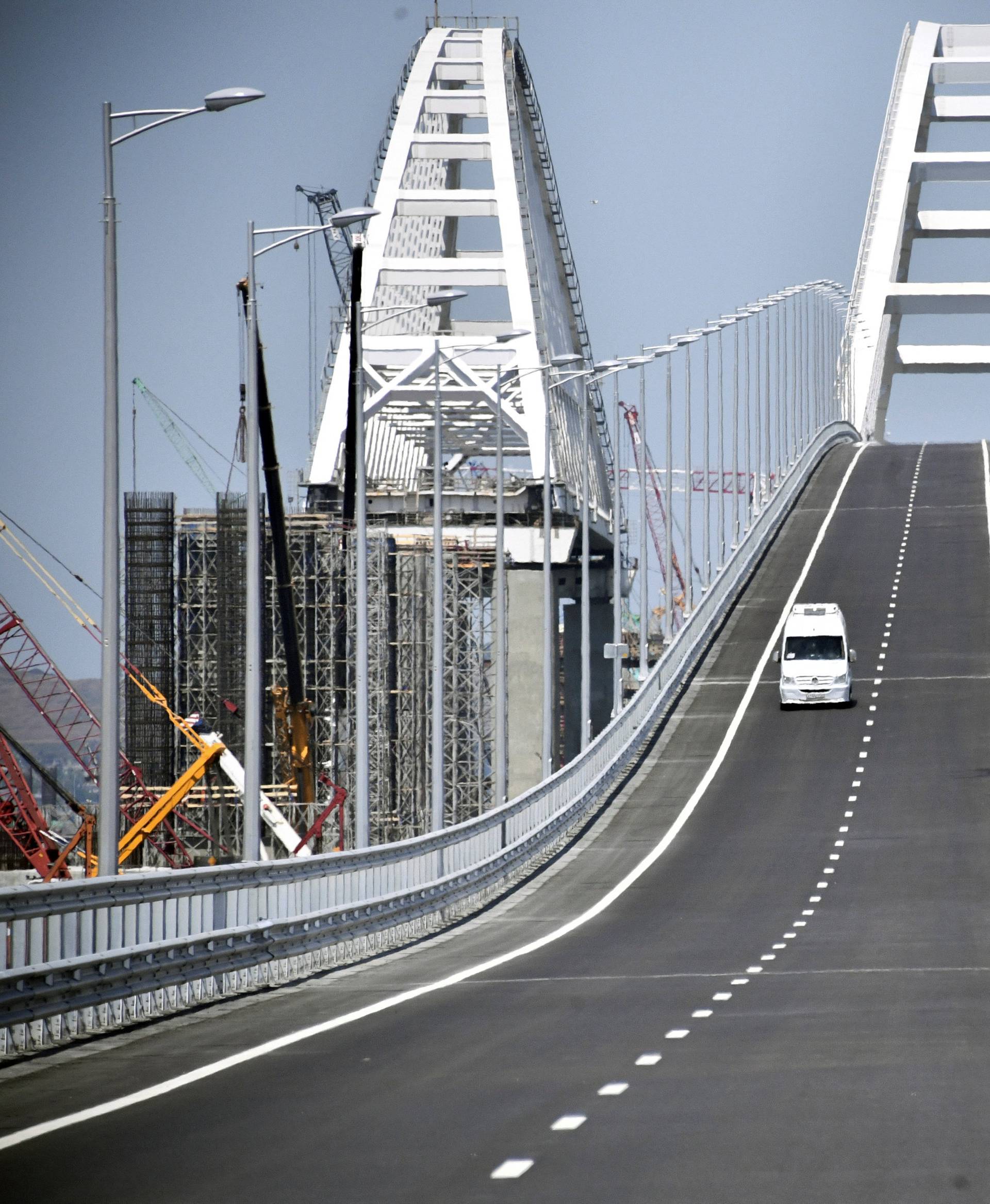 A vehicle drives along a bridge, which was constructed to connect the Russian mainland with the Crimean Peninsula across the Kerch Strait