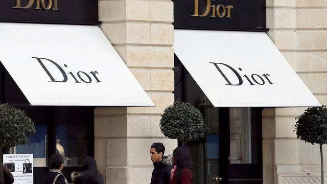 Logos of Dior brand are seen outside a Dior store in Paris