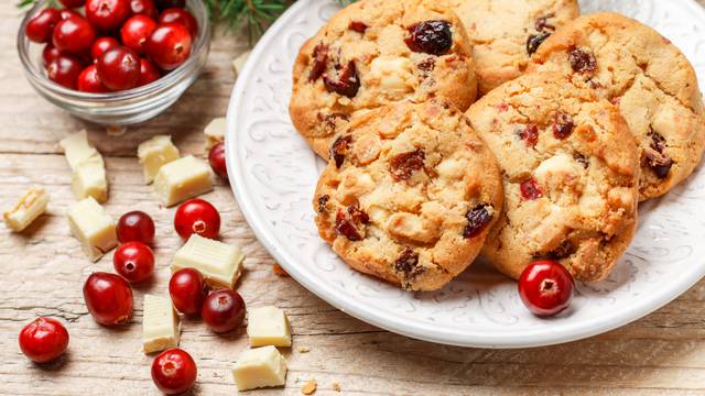 Homemade Christmas cranberry cookies with white chocolate in a bowl on the table. Rustic style. Selective focus